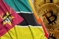Mozambique flag and cryptocurrency falling trend with many golden bitcoins