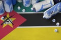 Mozambique flag and few used aerosol spray cans for graffiti painting. Street art culture concept