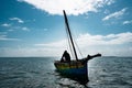 Mozambique's Coastal Charm: A Man and His Dhow Boat Royalty Free Stock Photo