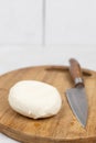 Mozarella cheese on the cutting wooden board with knife Royalty Free Stock Photo