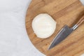 Mozarella cheese on the cutting wooden board with knife Royalty Free Stock Photo