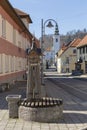 Mozirje medieval city in Slovenia, old hand water pump and church in distance Royalty Free Stock Photo