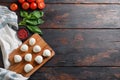Mozzarella cheese, basil tomato cherry over old wood background table top view space for text