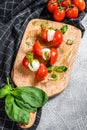 Mozzarella Cheese canape sandwiches on skewers, Caprese salad. gray background. top view Royalty Free Stock Photo