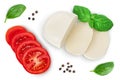 Mozzarella cheese sliced with basil leaf and tomato isolated on white background with clipping path. Top view. Flat lay Royalty Free Stock Photo