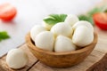 Mozzarella cheese in wooden bowl