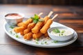 mozzarella sticks with a bite taken, displaying stringy cheese