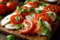 Mozzarella and tomato salad. Fresh italian caprese salad with mozzarella and tomatoes on wooden board