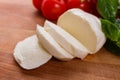 Mozzarella tomatoes and basil on a wooden rustic background Royalty Free Stock Photo