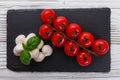 Mozzarella tomatoes and basil on a wooden rustic background Royalty Free Stock Photo