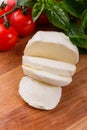 Mozzarella tomatoes and basil on a wooden rustic background Royalty Free Stock Photo