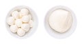 Mozzarella, mini balls (bambini bocconcini) and a big ball, in white bowls