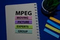 MPEG - Moving Picture Experts Group acronym write on sticky note isolated on Office Desk Royalty Free Stock Photo