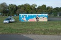 Mr Jean-Luc Bitter, sports coach, paints a fence of the tennis court of Camping Les Mouettes in Gondrexange.