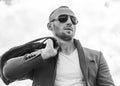 Mr. Perfection. Close-up of handsome young man wearing suit jacket, sunglasses and looking away while standing against Royalty Free Stock Photo