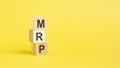 MRP - text on wooden cubes, on yellow background