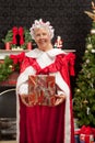 Mrs. Clause holding a Christmas present Royalty Free Stock Photo