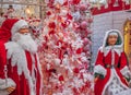 Mrs. Santa and her husband Santa Claus greeting the guests at the entery of a house. Smiling Santa Claus and Mrs. Santa Royalty Free Stock Photo