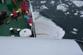 Observers watch as an ice floe is crushed under their ship
