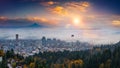 Mt. Hood and Portland downtown with rolling fog and autumn foliage in shining sunrise and colorful clouds