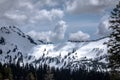 Sunlit skies emitting shadows and light across the snow-blanketed mountaintop