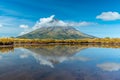 Mt. Taranaki reflected on a pond during a sunny day at New Zealand