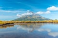 Mt. Taranaki reflected on a pond during a sunny day at New Zealand