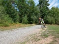 The mtb biker ride on the gravel road from the forest