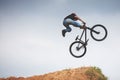 Mtb dirt rider doing trick on a jump