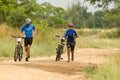 MTB Riders running next to bicycle