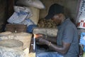 A Vendor Sealing Nylon Bags with a Candle