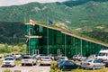 Mtskheta Georgia. Contemporary Green Glass Police Station Building With Parking Mointains Background