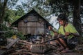Indigenous Malaysian aboriginal craftman making a knife for hunting