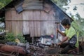 Indigenous Malaysian aboriginal craftman making a knife for hunting