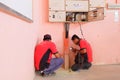 Technician wiring cable in front of electrical panel for control and distribute electrical power system in building