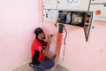 Technician wiring cable in front of electrical panel for control and distribute