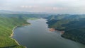 Muak Lek reservoir in Saraburi from aerial bird eye view. Beautiful unseen nature at Muak Lek dam with roadway beside with water a