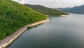 Muak Lek reservoir in Saraburi from aerial bird eye view. Beautiful unseen nature at Muak Lek dam with roadway beside with water a