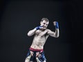 Muay thai fighter isolated on black background