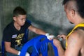 Muay thai fighter swathing hand in boxing bandage