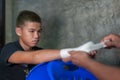 Muay thai fighter swathing hand in boxing bandage