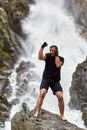 Muay thai fighter training by the waterfall