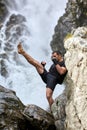 Muay thai fighter training by the waterfall