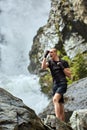 Muay thai fighter training by the waterfall