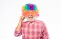 So much fun. happy birthday. corporate party. mature bearded man in colorful wig and party glasses. Crazy man in playful