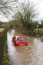 Car submerged in a flooded road in Much Hadham. UK Royalty Free Stock Photo