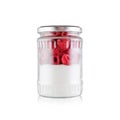 So much sugar is in the usual jam, a glass jar with sugar and raspberries isolated on white