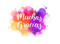 Muchas gracias - Thank you very much in Spanish. Handwritten modern calligraphy lettering text on abstract watercolor paint splash