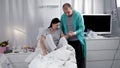 Muchina helps his wife in the hospital to get out of bed, helps to walk