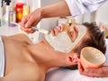 Mud facial mask of woman in spa salon. Face massage. Royalty Free Stock Photo